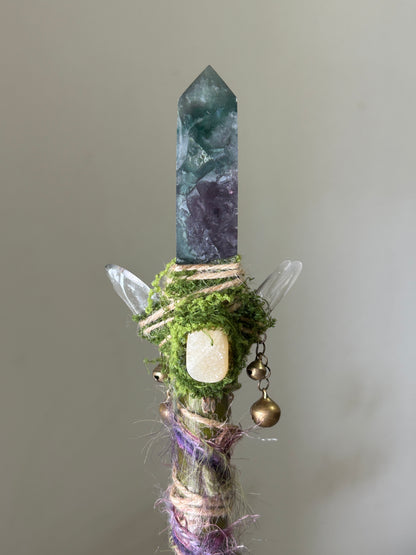 Close-up of green fluorite point with moss wrap and pastel twine