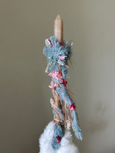 Back view of bright wand with star charm and soft colorful threads