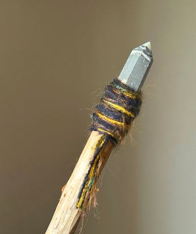 Back view showing natural wood texture, embedded agate drop, and grounding fibers
