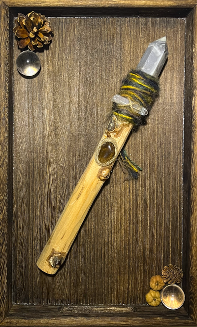 Flat lay of rugged storm-themed wand with embedded grey agate and earthy tone wrapping