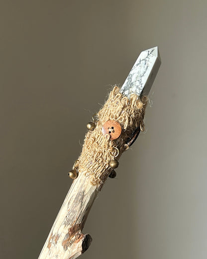 Back view of howlite ritual wand with bronze bells and rustic hemp fiber