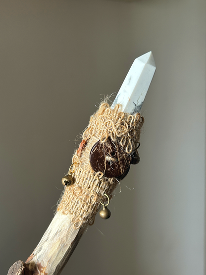 Close-up of pointed howlite crystal, coconut shell button, and rustic hemp wrapping