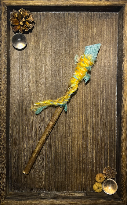 Flat lay of handcrafted amazonite wand with dancing threads on ceramic plate