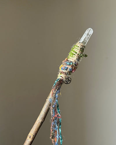 Back view of elemental-themed willow wand with flowing threads and pentacle charm