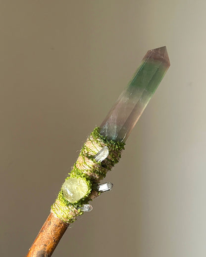 Front view of willow wand with green fluorite point, prehnite, and mossy fiber wrap
