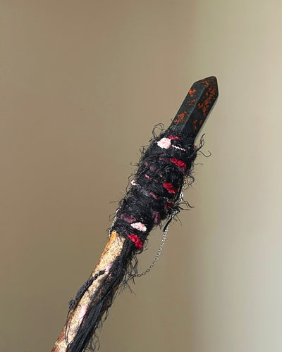 Rear view of willow wand with silver chain and dark fiber wrapping