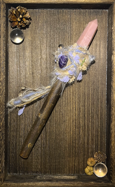 Flat lay of soft-toned wand featuring emotional healing crystals