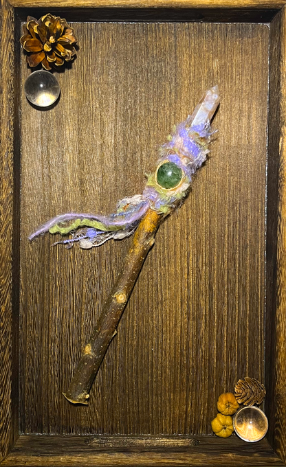Flat lay of spring-themed wand with Sakura Agate and soft fiber texture on ceramic plate